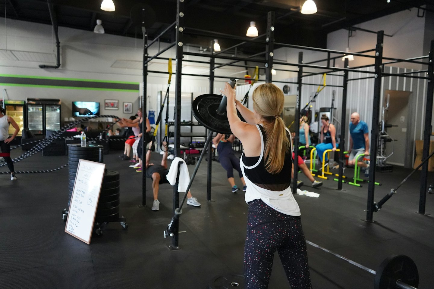 Erwachsene beim hochintensiven Intervalltraining in einem modernen Fitnessstudio.